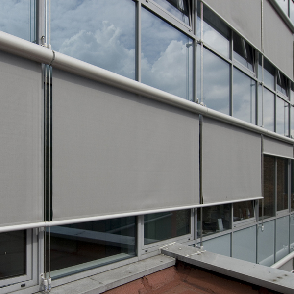 big modern grey exterior roller blinds on big glass building