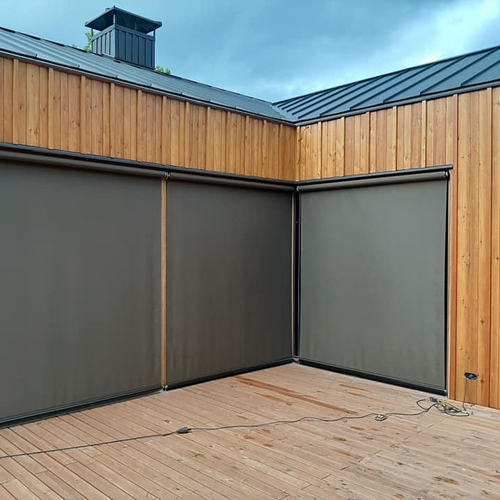 modern grey big roller blinds for windows on brown wooden facade modern house